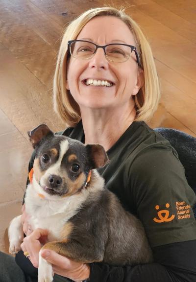 Michelle Hood smiling and holding Benton the dog